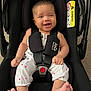 Gia joined the competition — help win amazing prizes! baby, infant, car_seat, child, smiling, happy, seatbelt, clothing, foot, hand, face, indoor, black, white, red, person, baby_clothes, safety, car_seat_harness, cute