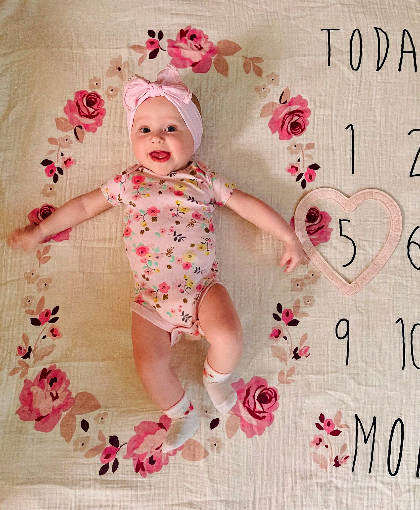 Lily joined the competition — help win amazing prizes! arm, baby, baby_products, baby_toddler_clothing, cheek, child, finger, font, hand, happy, head, headwear, magenta, pattern, person, pink, skin, sleeve, smile, textile