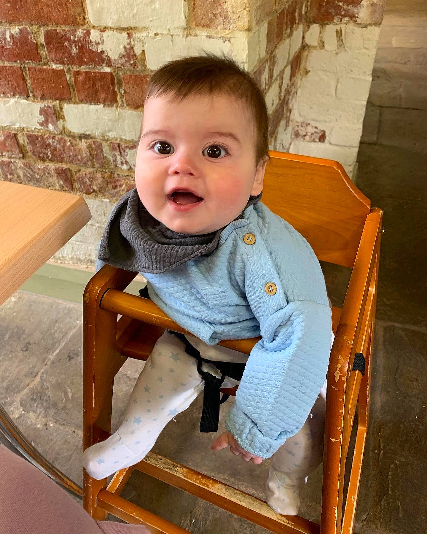 Louis is registered to the contest to win money with this photo: baby, baby_toddler_clothing, bench, chair, cheek, child, collar, comfort, flooring, fun, happy, hardwood, leisure, person, portrait_photography, sitting, sleeve, surprise, table, toddler