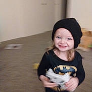 Aspen joined the competition — help win amazing prizes! toddler, child, smiling, batman_shirt, black_beanie, game_controller, indoor, carpet, toy, motion_blur, happy, person, young_child, playful, cute, hair, clothing, headwear, fun, living_room