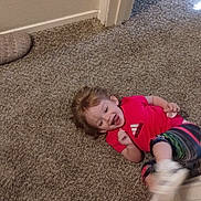 Aspen joined the competition — help win amazing prizes! adidas, candid, carpet, child, colorful_pants, doorframe, expression, floor, footwear, happy, home, indoor, laughing, person, playful, red_shirt, smiling, toddler, wall, young_child