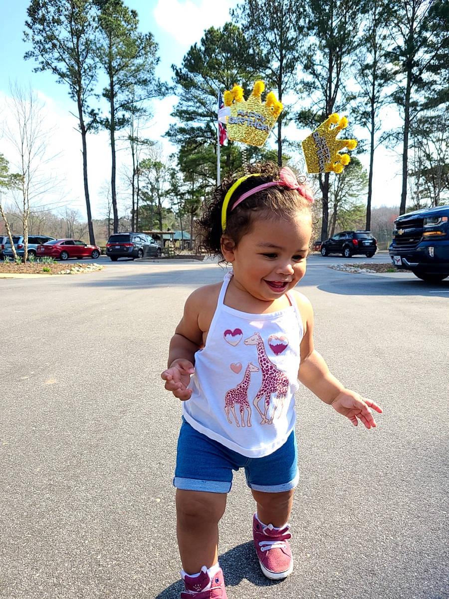 Naiomi joined the competition — help win amazing prizes! asphalt, car, electric_blue, footwear, fun, happy, hat, joy, leisure, person, recreation, road, shorts, sky, sleeve, sneakers, t_shirt, toddler, travel, tree