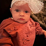 Willow joined the competition — help win amazing prizes! baby, bow, child, close_up, cozy, cute, expression, headband, human, indoor, infant, person, pink_clothing, portrait, sitting, soft_lighting, velvet_bows, warm_colors, wide_eyes, young_child