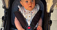 Willow joined the competition — help win amazing prizes! baby, stroller, child, infant, blue_eyes, sitting, outdoor, sunlight, canopy, clothing, straps, safety_buckle, cute, curious, legs, footwear_absent, pavement, summer, portrait, person