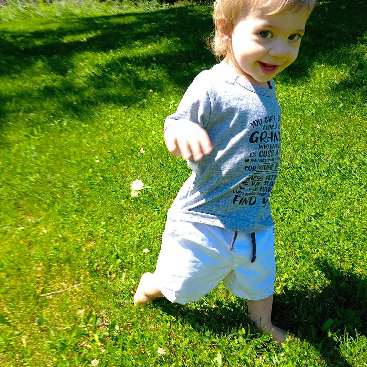 Elius is registered to the contest to win money with this photo: backyard, boy, child, clothing, face, field, grass, green, head, lawn, male, nature, outdoors, park, person, photography, plant, portrait, shorts, yard
