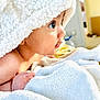 baby, blanket, face, hand, soft_texture, curious, indoors, closeup, child, skin, cozy, cute, portrait, expression, infant, toddler, white, warm, comfort, sleepwear