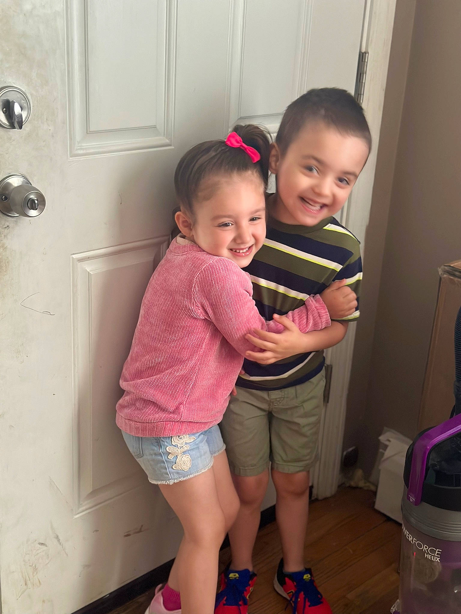 Autumn is registered to the contest to win money with this photo: child, door, flooring, fun, gesture, happy, joint, joy, leg, magenta, person, photograph, pink, shorts, shoulder, skin, sleeve, smile, standing, thigh