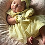 baby, sleeping, yellow_clothing, headband, mittens, blanket, soft_texture, infant, peaceful, cute, newborn, portrait, indoors, tulle_skirt, foot, hand, resting, cozy, child, adorable