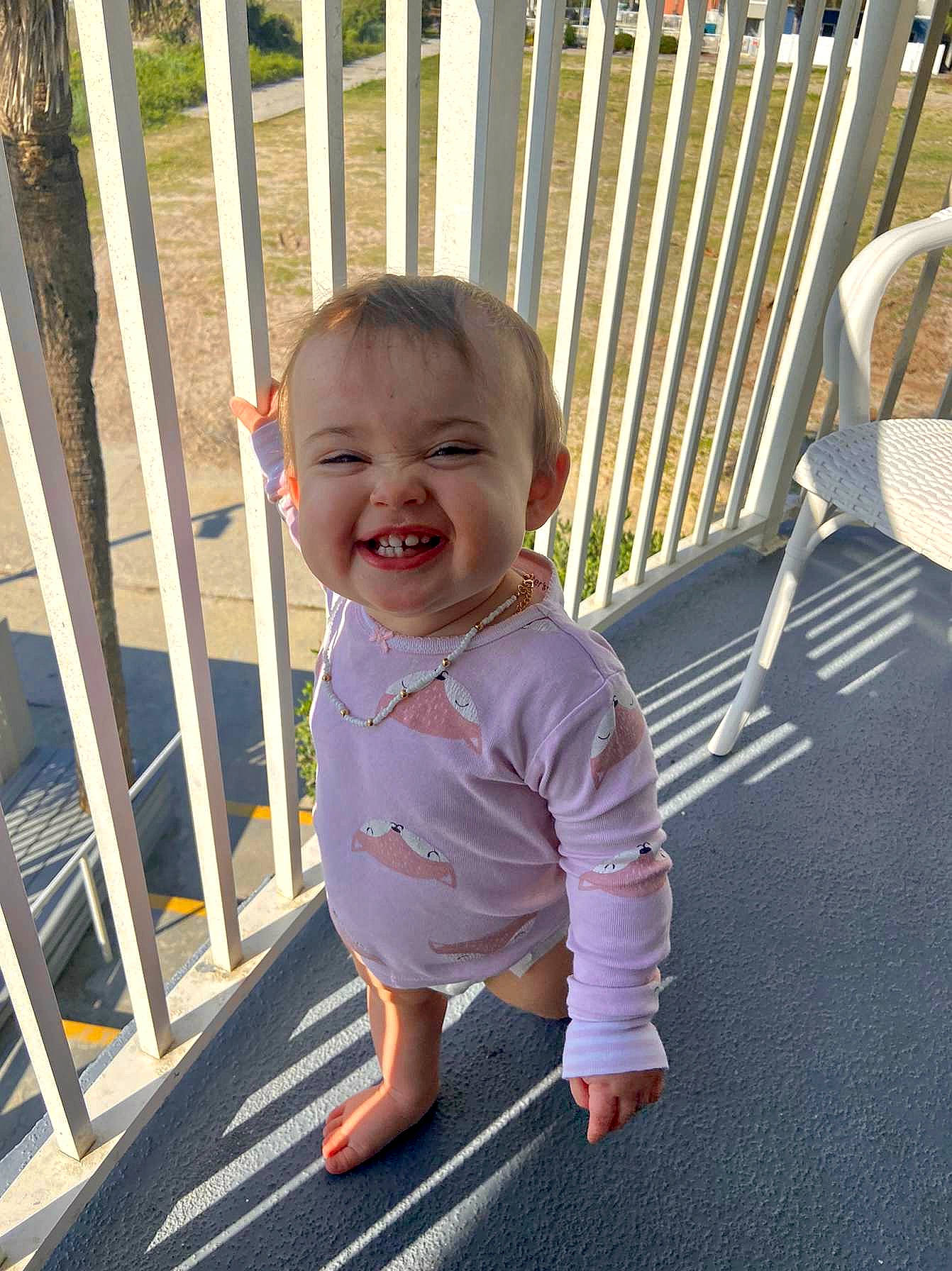 Lauryn joined the competition — help win amazing prizes! baby, baby_toddler_clothing, cheek, dress, eye, face, fence, flooring, grass, hairstyle, happy, human_body, joy, leisure, mammal, person, public_space, skin, sleeve, smile