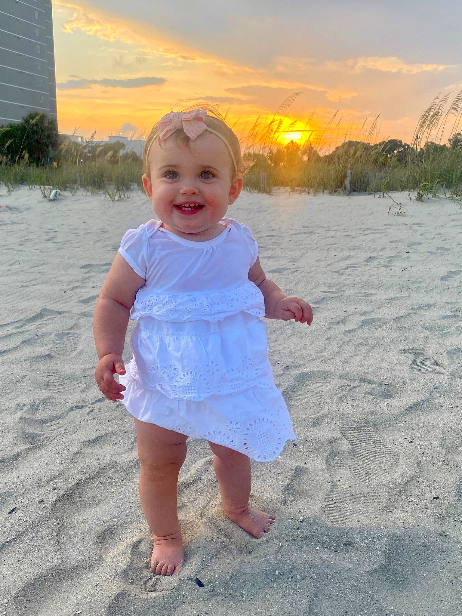 Lauryn joined the competition — help win amazing prizes! baby, baby_toddler_clothing, barefoot, body_of_water, child, cloud, foot, fun, grass, happy, joy, people_in_nature, person, plant, sand, skin, sky, sleeve, smile, summer