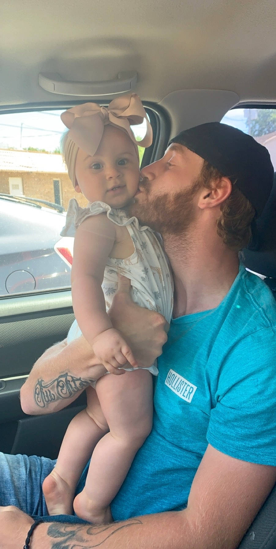 Peyton is registered to the contest to win money with this photo: abdomen, car, child, driving, family_car, fun, headwear, leg, person, smile, thigh, vacation, vehicle