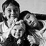 Safiya participe au concours pour gagner de l'argent avec cette photo : baby, child, sibling, black_and_white, portrait, smile, headband, couch, clothing, young, happy, face, person, indoors, closeup, hand, hoodie, casual, toddler, boy