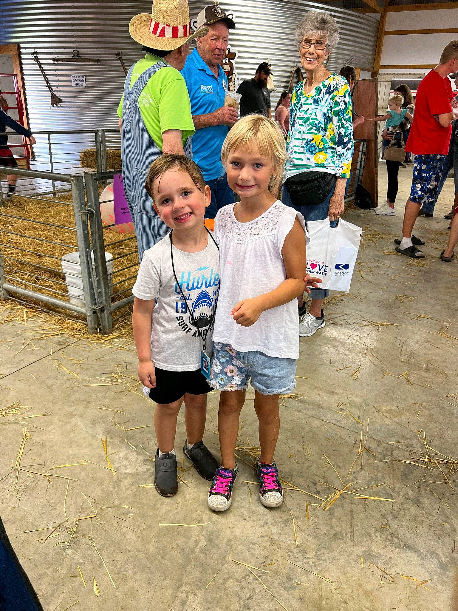 Cali is registered to the contest to win money with this photo: child, cowboy_hat, event, footwear, fun, happy, hat, headwear, joy, leisure, person, recreation, shoe, shorts, sidewalk, sneakers, street, style, sun_hat, t_shirt