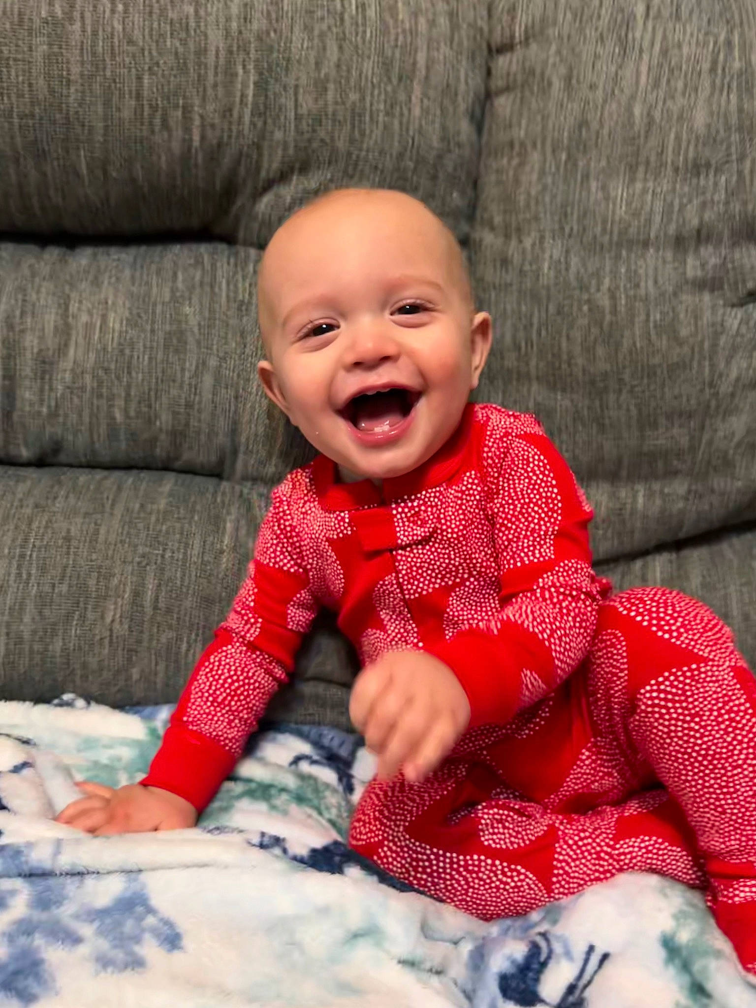 Ezra is registered to the contest to win money with this photo: baby, baby_toddler_clothing, cheek, comfort, eye, face, facial_expression, happy, head, human_body, leg, lip, mouth, nose, outerwear, person, skin, sleeve, smile, textile