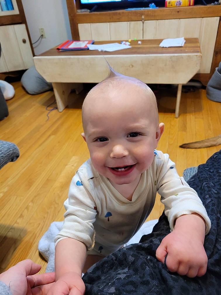 Ezra joined the competition — help win amazing prizes! baby, baby_toddler_clothing, chair, cheek, desk, eye, finger, floor, flooring, fun, gesture, hand, happy, hardwood, joy, person, skin, smile, table, thumb