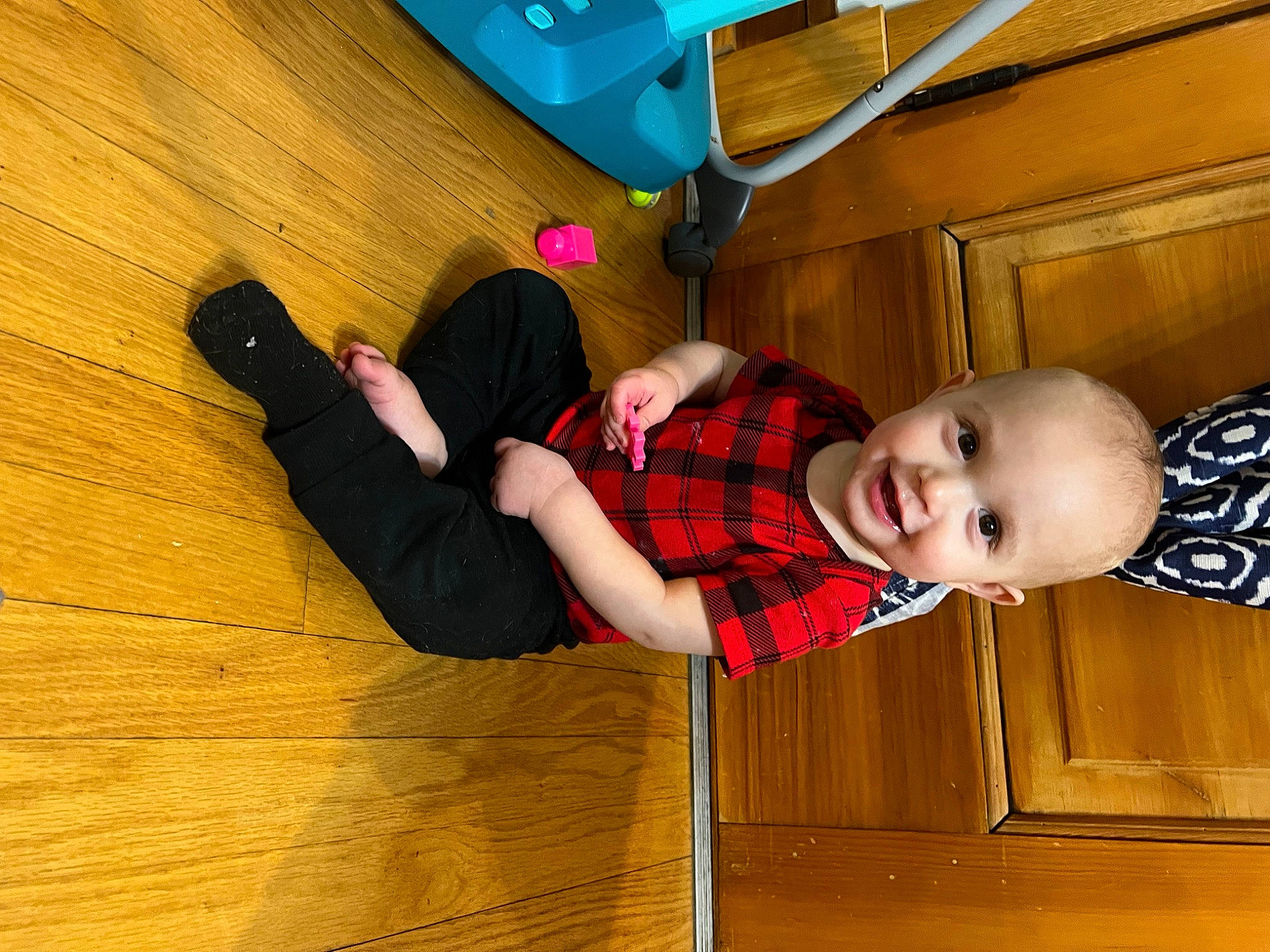 Ezra is registered to the contest to win money with this photo: baby_toddler_clothing, child, comfort, floor, flooring, fun, happy, hardwood, human_leg, joy, knee, leg, leisure, person, sitting, smile, sock, thigh, toddler, varnish
