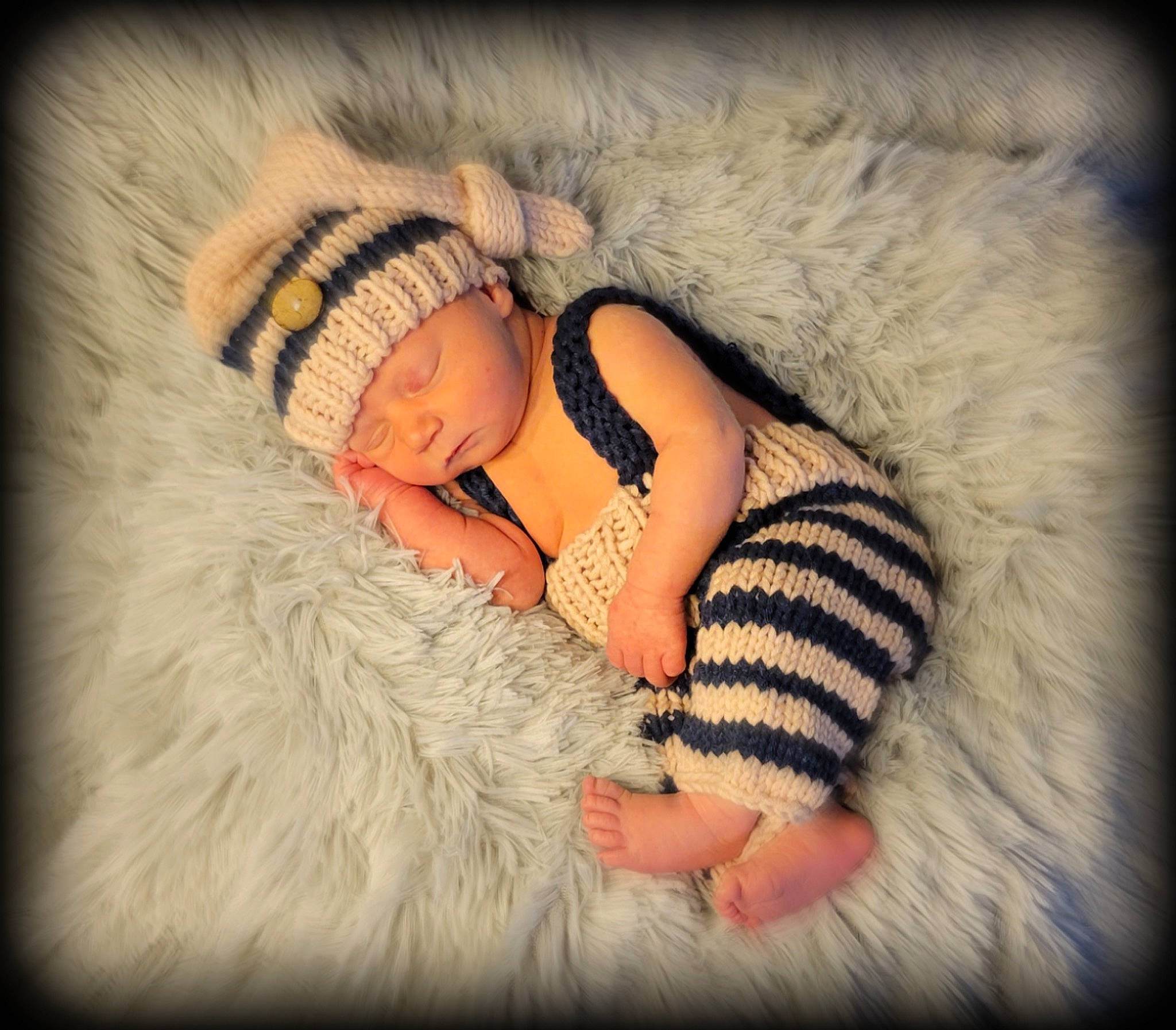 Jersey is registered to the contest to win money with this photo: art, baby, baby_sleeping, baby_toddler_clothing, cap, comfort, eyelash, flash_photography, fur, gesture, happy, headgear, headwear, knit_cap, linens, mammal, pattern, person, skin, textile
