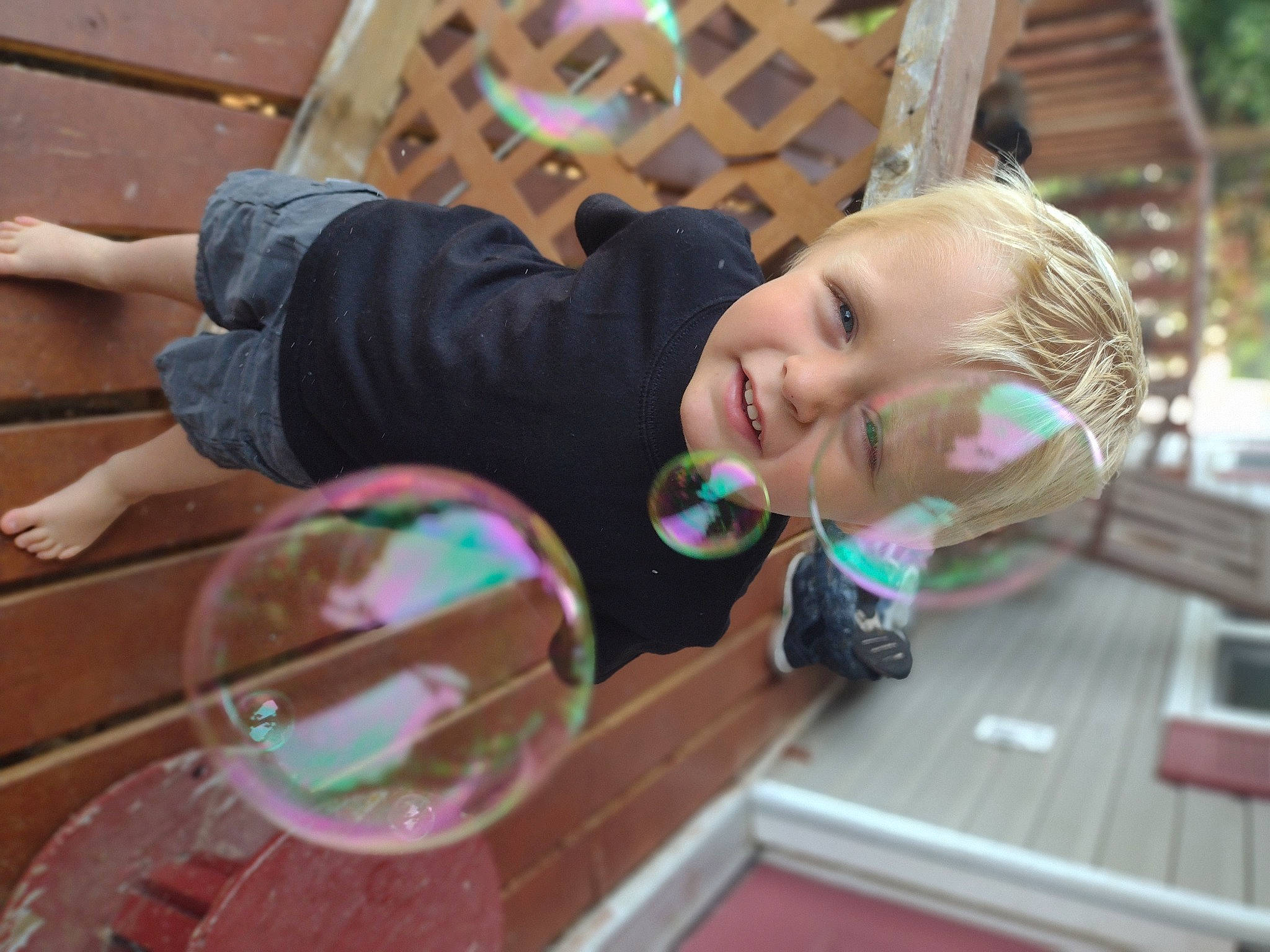 Greysen is registered to the contest to win money with this photo: blond, child, city, eyewear, finger, fun, happy, leisure, magenta, outdoor_play_equipment, person, pink, play, recreation, sitting, smile, summer, toddler, tree, vacation