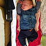 baby, sleeping, denim_shirt, navy_pants, bassinet, cushion, blanket, infant, footwear, cozy, patterned_fabric, striped_hat, child, peaceful, indoors, newborn, sleep, cute, clothing, rest