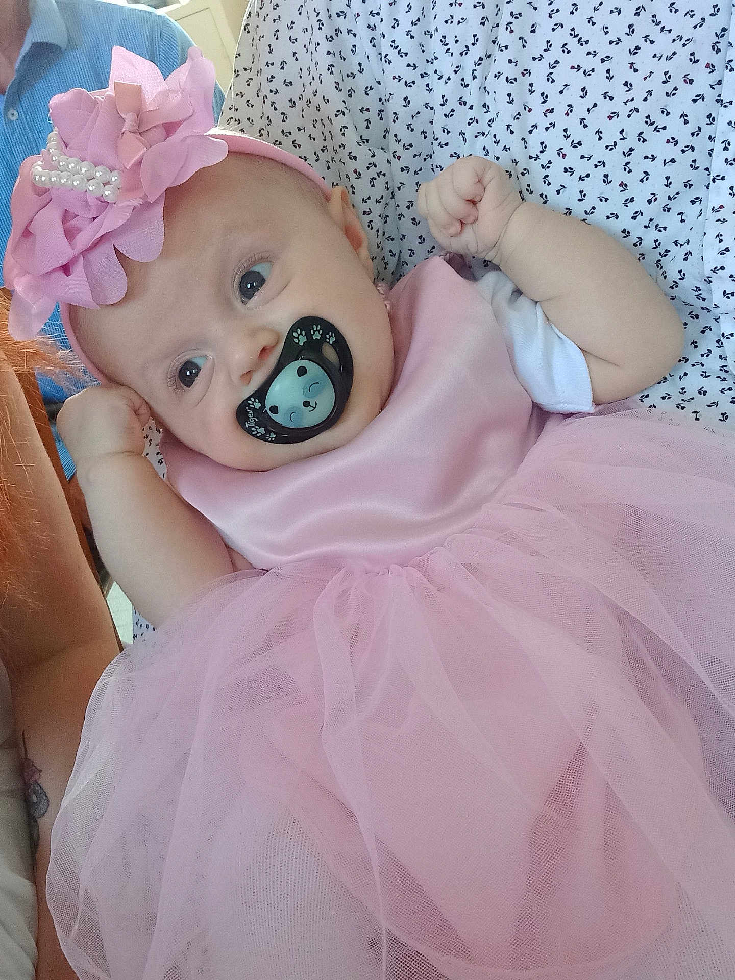 Yuna participe au concours pour gagner de l'argent avec cette photo : baby, pacifier, pink_dress, headband, pearls, tutu, infant, cute, child, person, clothing, fabric, hand, face, apparel, pattern, sitting, soft_texture, portrait, holding