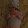 Audrey joined the competition — help win amazing prizes! baby, infant, pacifier, mittens, headband, flower, blanket, yellow, peach, white, clothing, lying_down, soft_texture, cute, child, indoor, portrait, newborn, baby_girl, comfort