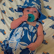 Audrey joined the competition — help win amazing prizes! baby, pacifier, blue_dress, hat, bed, sheet, pattern, trucks, infant, clothing, lying_down, cute, wide_eyes, hand, foot, indoors, child, face, sleepwear, comfort