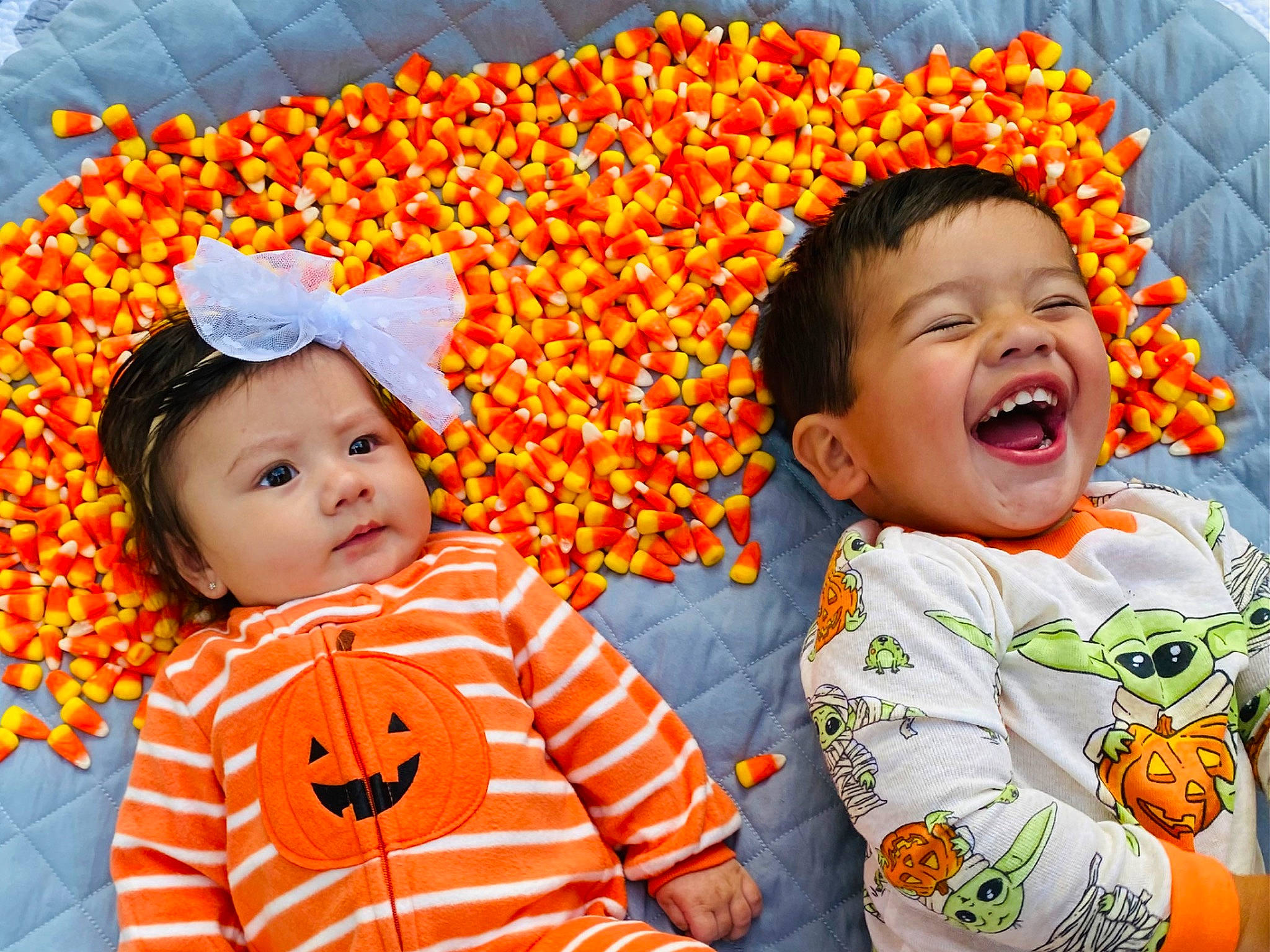 Marcel is registered to the contest to win money with this photo: baby, baby_toddler_clothing, cheek, child, eye, face, facial_expression, fun, happy, head, headwear, leaf, nose, orange, organ, people_in_nature, person, playing_with_kids, sleeve, smile