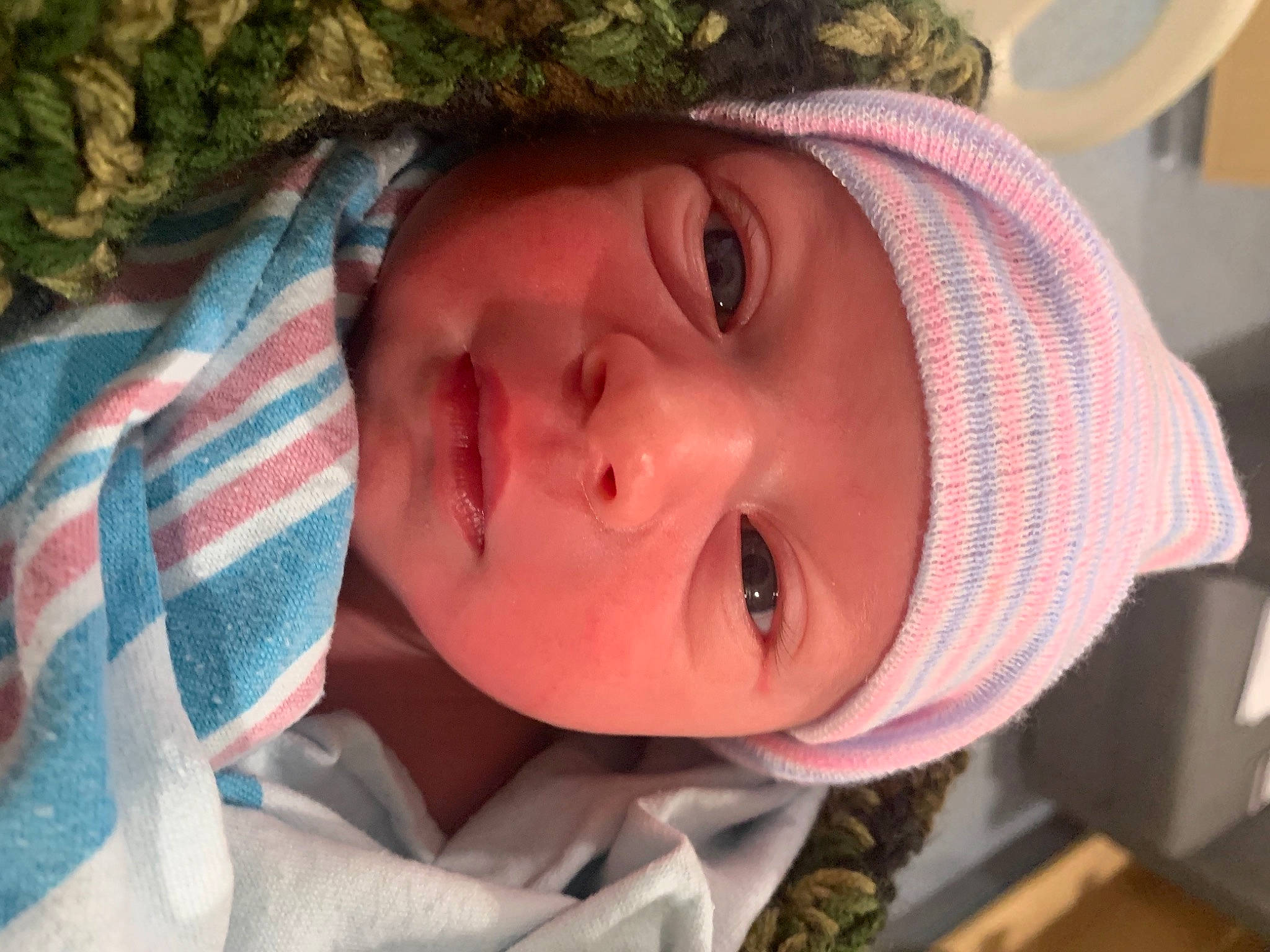 Bennett is registered to the contest to win money with this photo: baby_toddler_clothing, bonnet, cheek, child, chin, close_up, eyebrow, eyelash, forehead, headgear, headwear, jaw, knitting, lip, nose, organ, person, photography, skin, textile