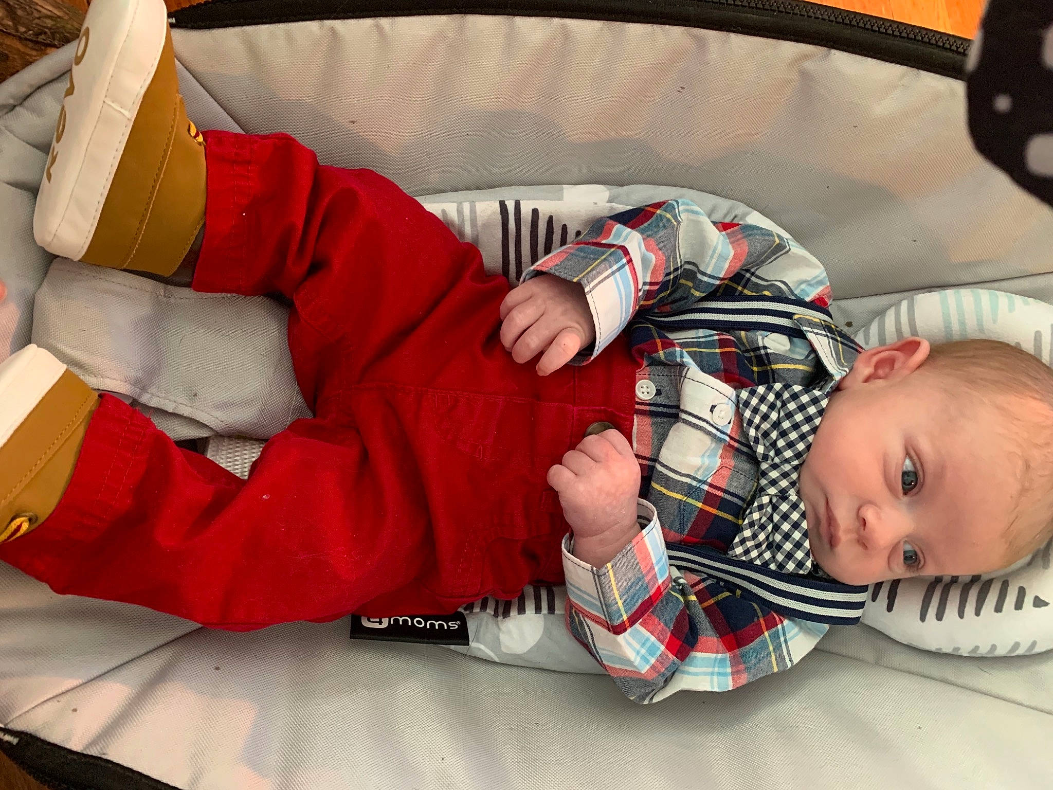 Bennett is registered to the contest to win money with this photo: baby, baby_toddler_clothing, carmine, child, comfort, event, finger, flooring, fun, human_body, human_leg, knee, lap, leg, person, santa_claus, sitting, sock, textile, thigh