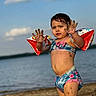 child, beach, sand, water, floaties, swimsuit, sunny, summer, outdoor, playing, hands, sandy, portrait, person, vacation, holiday, fun, youth, toddler, nature