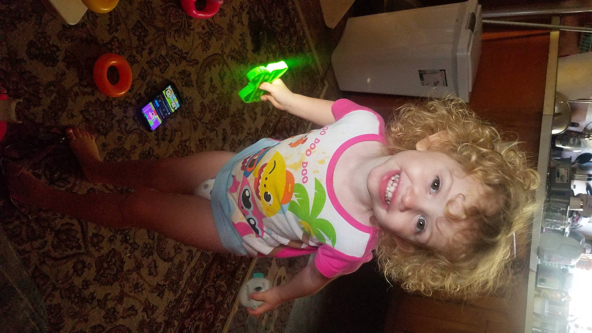 Paislee is registered to the contest to win money with this photo: baby, baby_toddler_clothing, carton, cheek, child, floor, flooring, fun, happy, human_leg, joy, leg, magenta, party, person, pink, play, shipping_box, smile, t_shirt