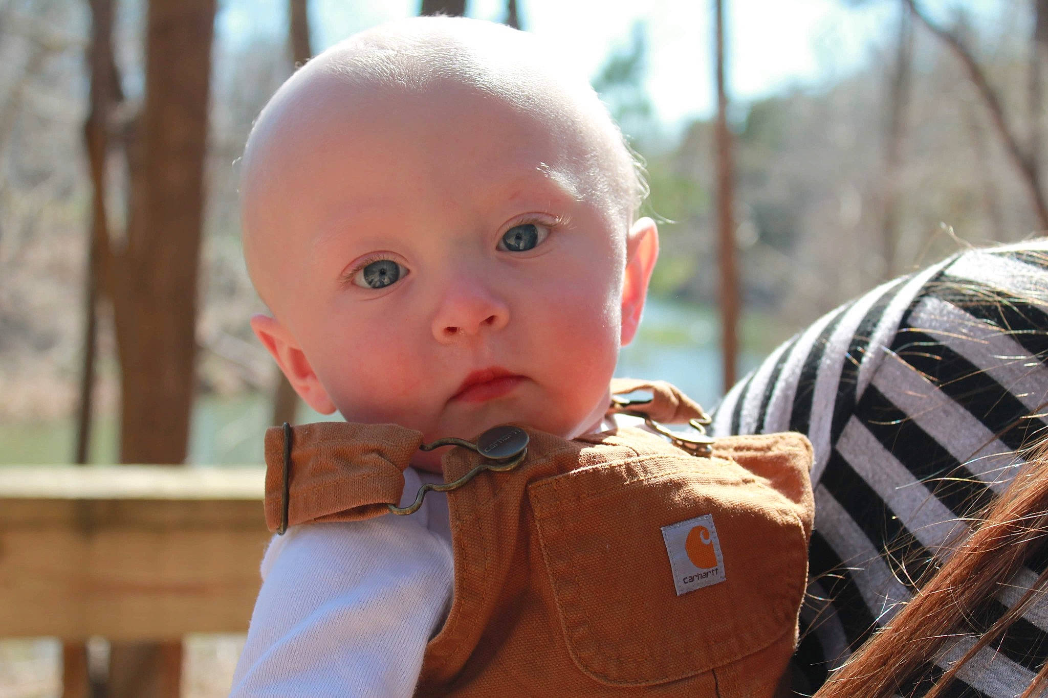 Brenden is registered to the contest to win money with this photo: baby, baby_toddler_clothing, cheek, child, fun, grass, happy, leisure, nose, person, sitting, skin, surprise, toddler, wood