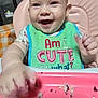 baby, bib, cake, crumbs, feeding, highchair, messy, smiling, happy, face, hand, food, indoor, child, cute, pink, green, clothing, table, celebration