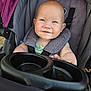 Alruna joined the competition — help win amazing prizes! baby, child, stroller, seatbelt, smile, face, blue_eyes, head, arm, hand, fabric, purple, black, green_clothing, outdoor, sunlight, infant, cute, portrait, person