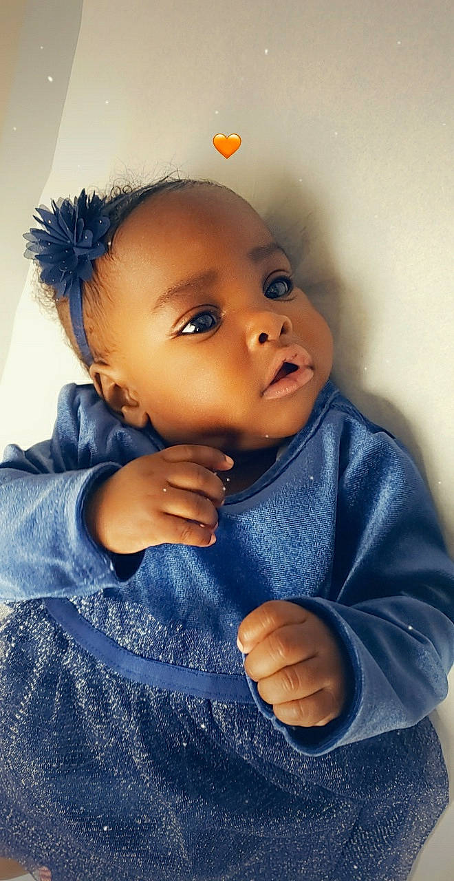 Diana is registered to the contest to win money with this photo: baby, blue, cheek, child, close_up, cool, eye, face, forehead, fun, hand, head, lip, mouth, nose, organ, person, photography, skin, smile
