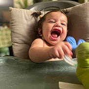 Aaliyah a rejoint le concours — aidez-le/la à gagner de superbes lots ! baby, blurred_background, child, cute, face, furniture, hair, happy, high_chair, home, indoor, joy, laughing, person, play, seat, smile, toddler, toy, young