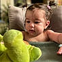 Aaliyah a rejoint le concours — aidez-le/la à gagner de superbes lots ! baby, child, curly_hair, cushion, cute, expression, face, focus, furniture, green, hands, high_chair, home, indoor, pigtails, play, soft_toy, stuffed_animal, toddler, toy