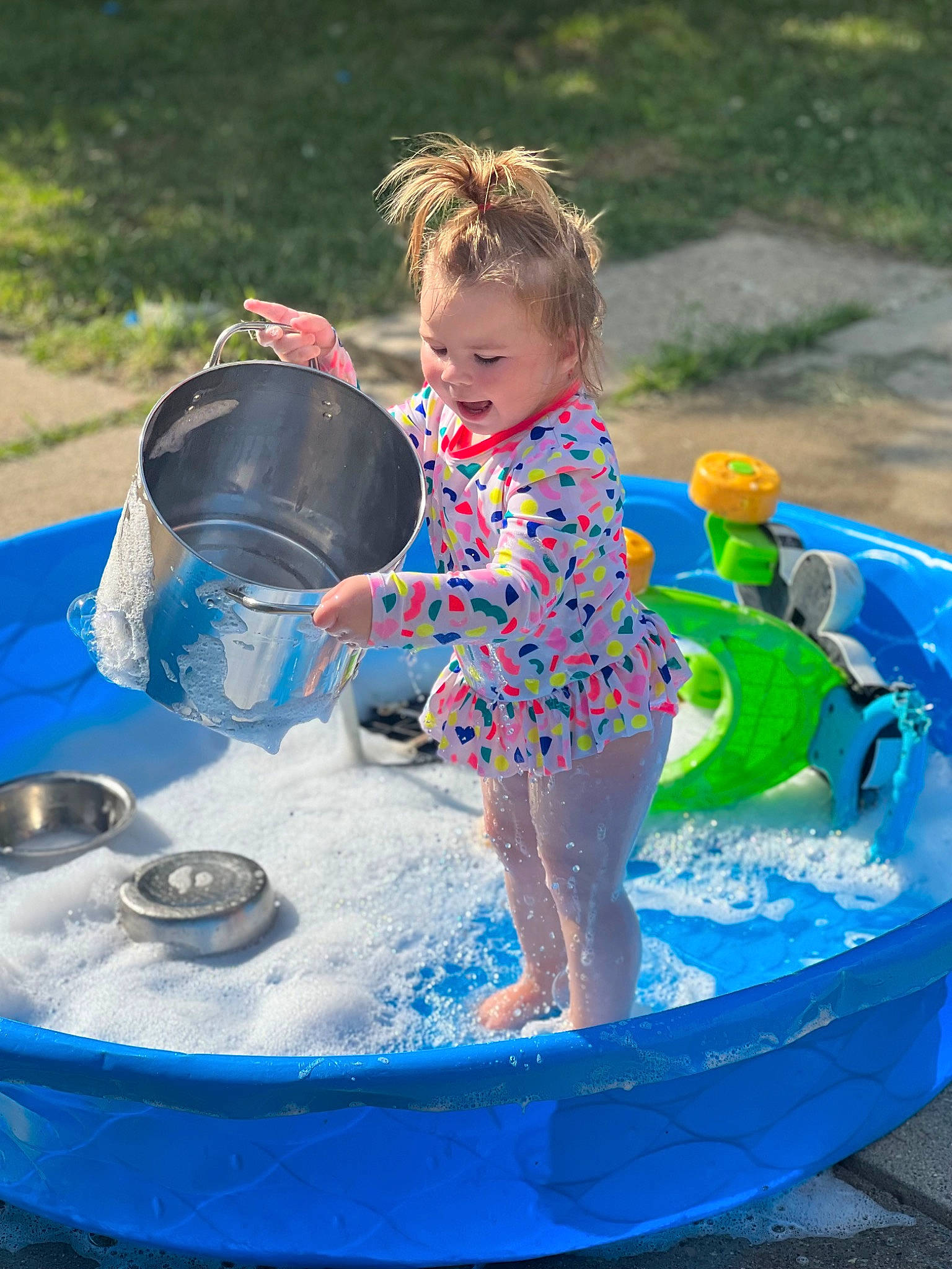 Stormi is registered to the contest to win money with this photo: aqua, azure, bathing, blue, child, electric_blue, event, fun, games, grass, happy, leisure, liquid_bubble, people, people_in_nature, person, play, recreation, toddler, vacation