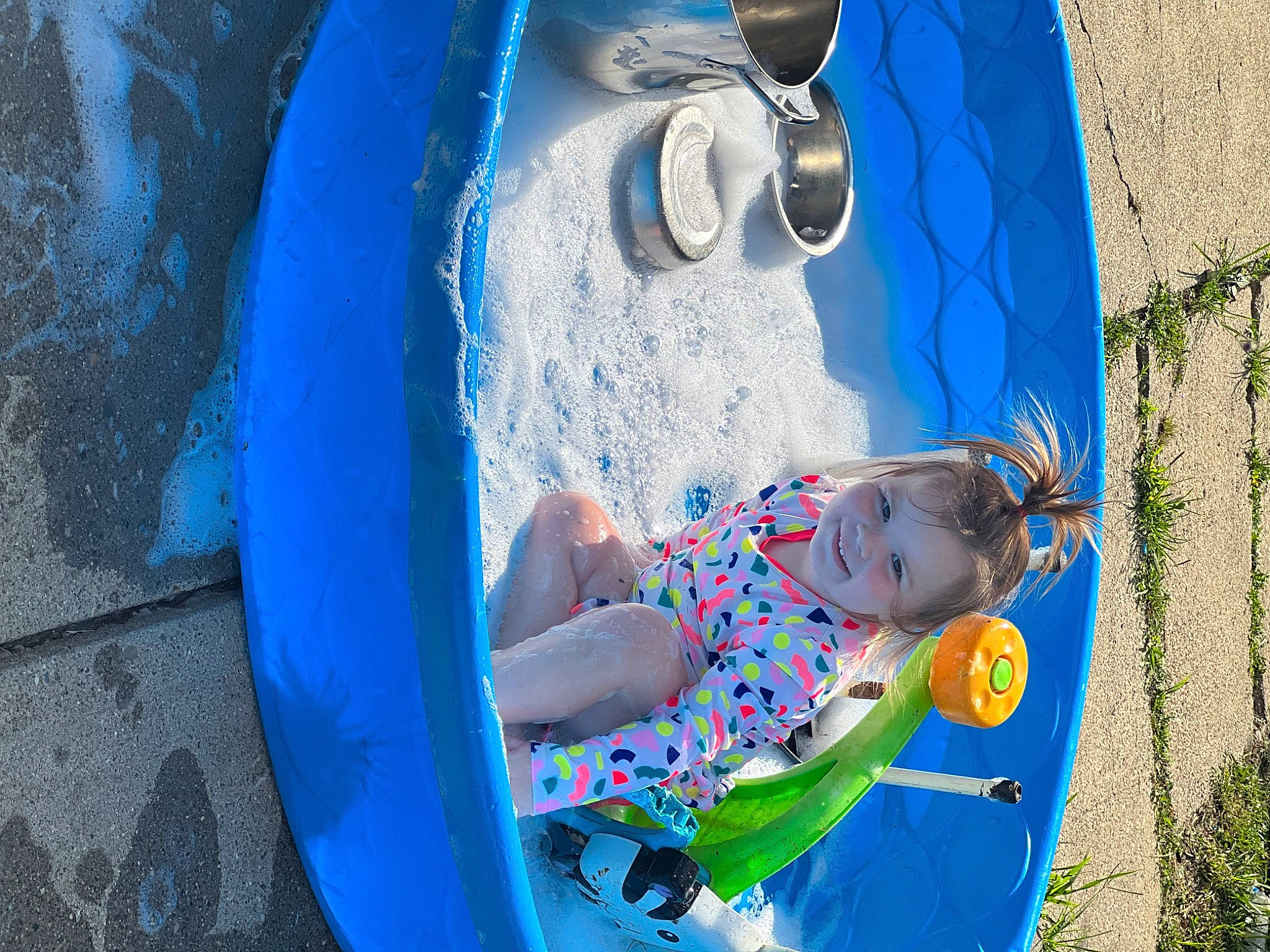 Stormi is registered to the contest to win money with this photo: azure, baby, baby_toddler_clothing, blue, child, circle, electric_blue, fun, grass, happy, joy, leisure, pattern, people_in_nature, person, plant, play, recreation, sitting, toddler