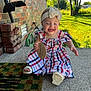 baby, child, girl, dress, headband, bow, smiling, outdoor, porch, brick_wall, concrete, sunlight, grass, greenery, happy, sign, footwear, sitting, person, summer