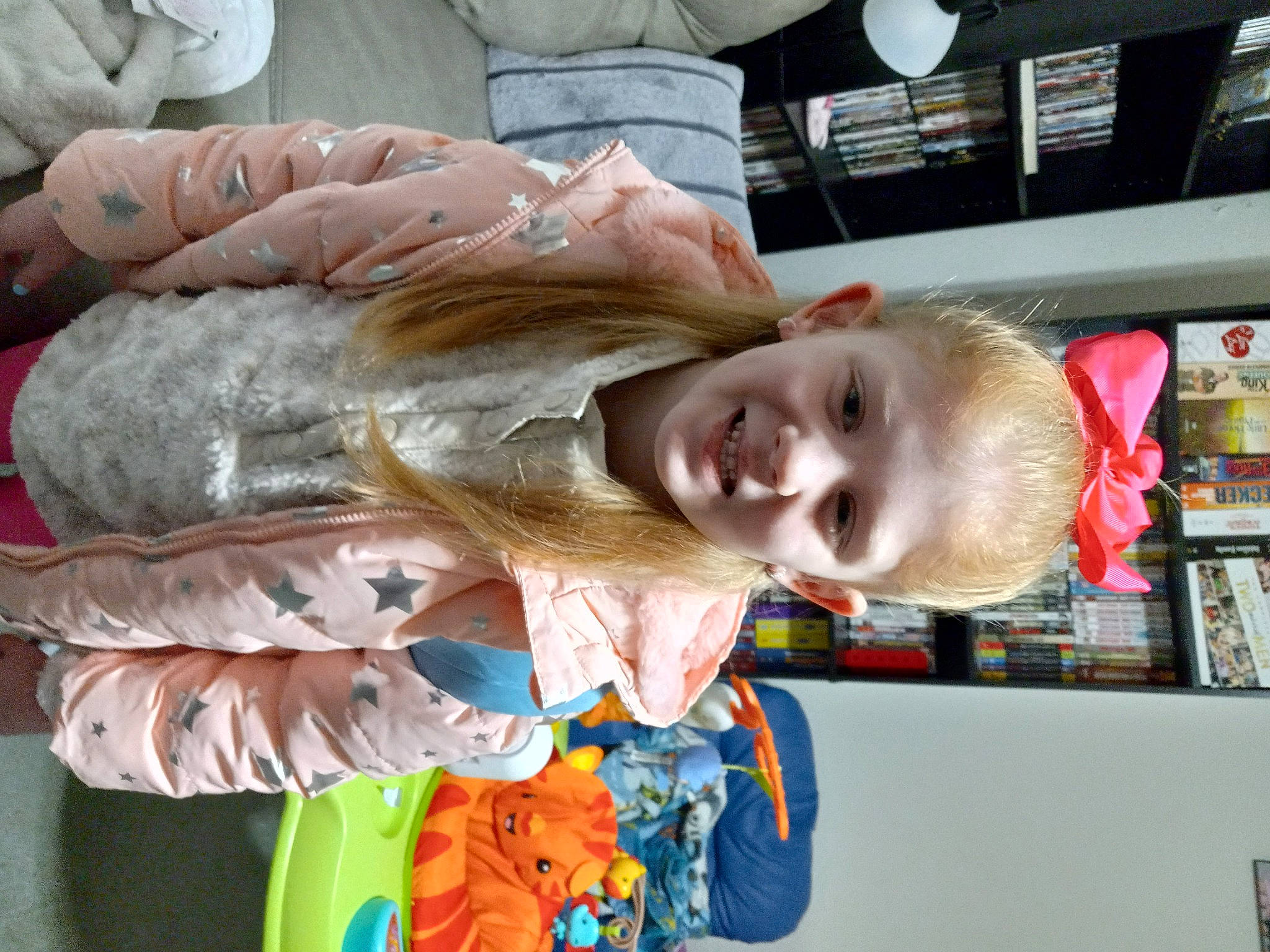 Cadence is registered to the contest to win money with this photo: baby, baby_products, bookcase, child, ear, fun, gesture, happy, joy, nail, person, room, shelf, shelving, smile, thumb, toddler, wrist