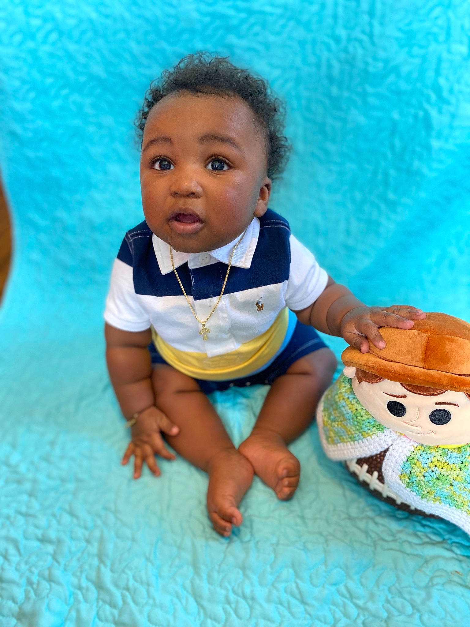 Chase is registered to the contest to win money with this photo: aqua, azure, baby, baby_toddler_clothing, barefoot, cheek, child, facial_expression, fun, hairstyle, happy, head, human, leisure, person, product, skin, sleeve, surprise, t_shirt