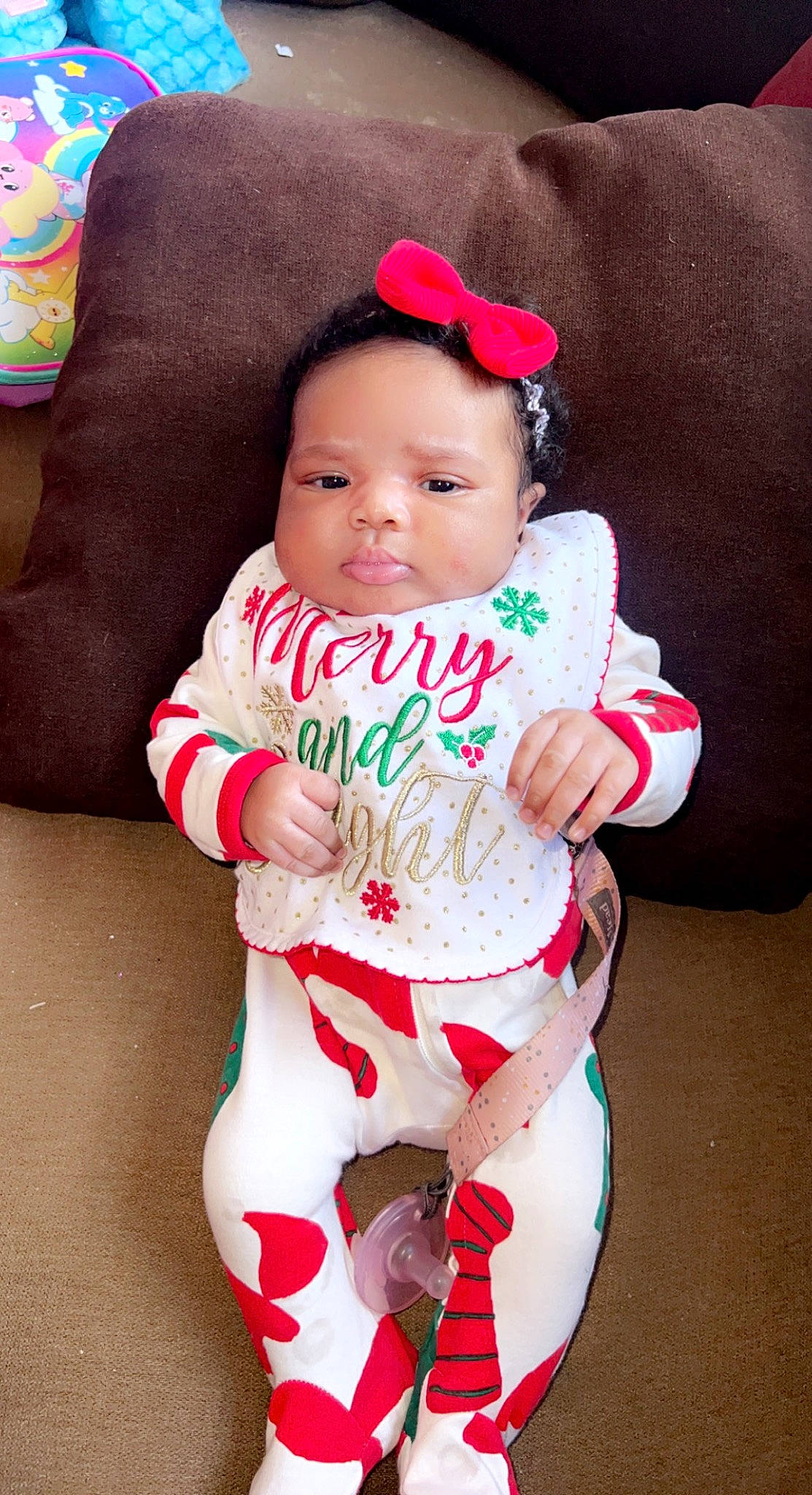 Aniya is registered to the contest to win money with this photo: baby, baby_toddler_clothing, cheek, child, christmas, christmas_eve, comfort, event, happy, head, holiday, human_body, lip, person, pink, red, sitting, skin, sleeve, sock