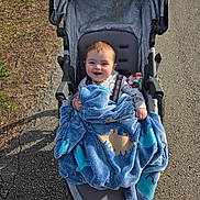 Tre joined the competition — help win amazing prizes! baby, blanket, stroller, child, smile, happy, outdoor, pavement, grass, sunlight, clothing, person, seat, wheel, park, cute, infant, bundle, daytime, comfort