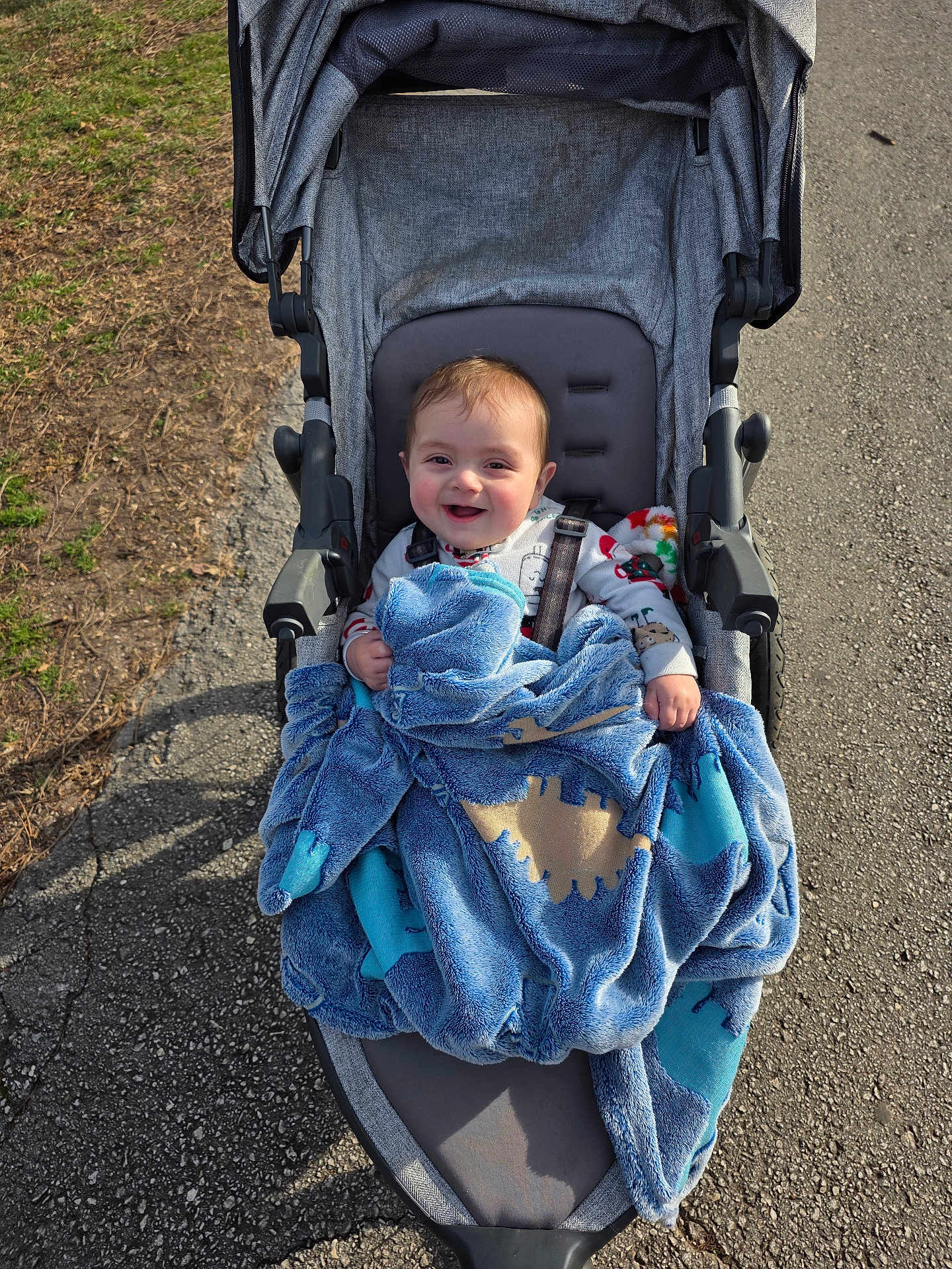 Tre joined the competition — help win amazing prizes! baby, blanket, stroller, child, smile, happy, outdoor, pavement, grass, sunlight, clothing, person, seat, wheel, park, cute, infant, bundle, daytime, comfort