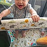 Harper joined the competition — help win amazing prizes! baby, child, playpen, smile, tongue_out, toy, animal_print, hand, feet, clothing, mesh, indoor, happy, cute, infant, person, colorful, play, fabric, pattern