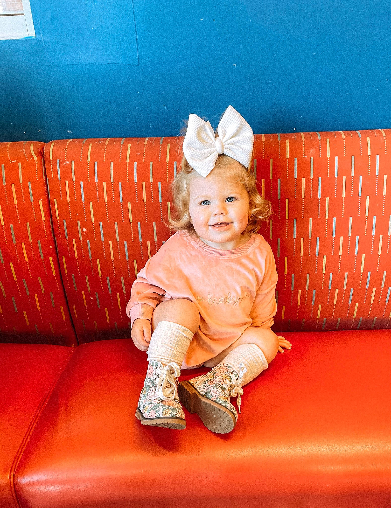 Breckyn is registered to the contest to win money with this photo: baby, baby_toddler_clothing, blue, child, comfort, costume_hat, couch, flooring, fun, happy, hat, human_leg, joy, pattern, person, room, sitting, sleeve, smile, sofa_bed