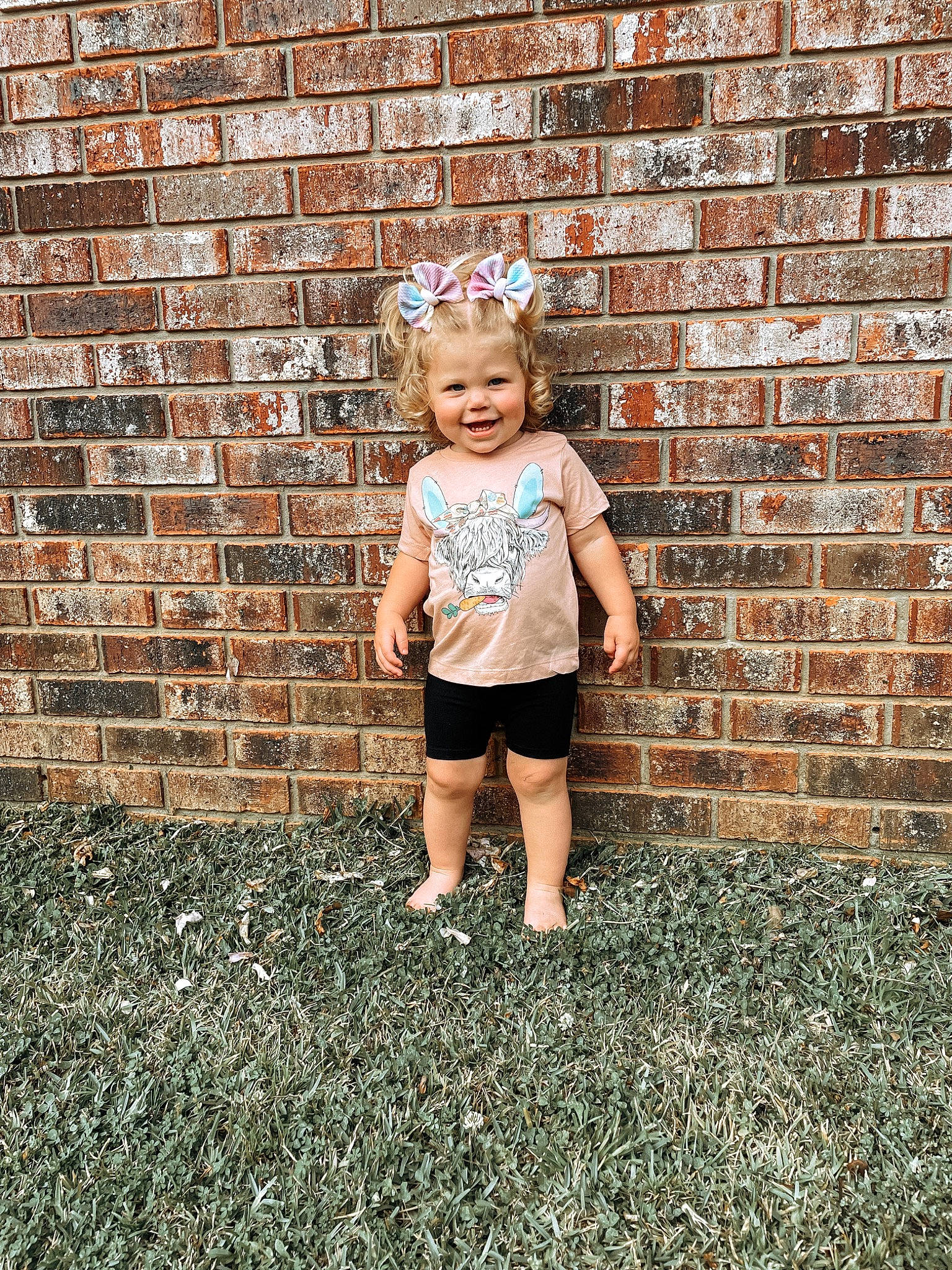 Breckyn is registered to the contest to win money with this photo: asphalt, blond, brick, brickwork, flash_photography, fun, grass, happy, human_leg, joy, leisure, people_in_nature, person, public_space, shorts, sitting, soil, t_shirt, tints_and_shades, toddler