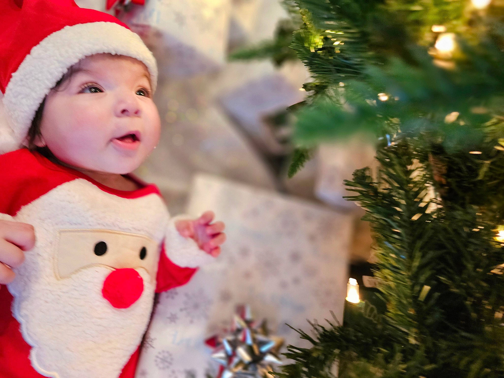 Reese is registered to the contest to win money with this photo: baby, baby_toddler_clothing, christmas, christmas_decoration, christmas_eve, christmas_ornament, christmas_tree, event, evergreen, grass, happy, hat, headwear, holiday, holiday_ornament, light, ornament, person, plant, sleeve