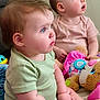 baby, child, infant, toddler, sitting, indoor, toy, plush_toy, blue_eyes, cute, curious, couch, blanket, clothing, person, face, head, furniture, soft_toy, room